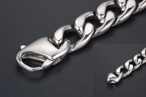 Detail of silver stainless steel Cuban link bracelet with large lobster clasp closure