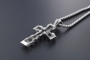Detail of silver titanium steel hollow cross pendant with a classic box chain necklace