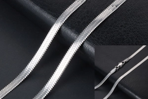 Macro shot of a silver flat snake chain necklace with high-density weaving and lobster clasp