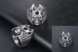 Close-up of vintage silver skull ring with feathered wings in gothic steel style
