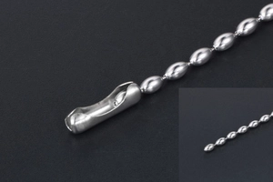 Macro shot of titanium steel ball chain connector with polished metal beads detail