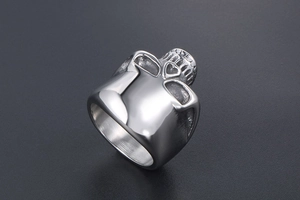 Macro detail of high polished vintage skull ring with rugged armor-style textured finish