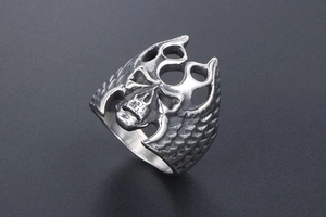 Detailed view of vintage gothic skull ring with embossed wing patterns and aged finish