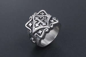 Detailed view of vintage silver cross relief and textured patterns on stainless steel ring