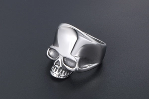 Macro shot of polished silver skull ring showcasing realistic bone texture and punk style