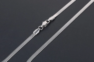 Macro detail of silver herringbone chain texture with secure lobster clasp closure