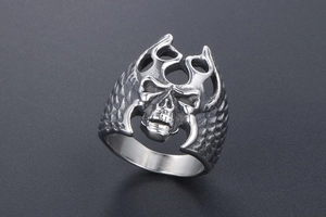 Close-up of gothic skull ring with flame detail and textured stainless steel finish