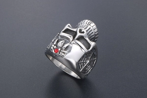 Close-up of punk gothic skull ring featuring red rhinestone and spider web detail
