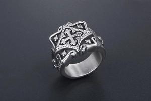 Detailed close-up of a vintage stainless steel men's ring with cross engraving and scrolls