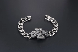 Close-up of a punk pirate skull and cross bracelet in vintage silver finish steel