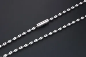 Detailed macro view of silver titanium steel bead chain with cylindrical metal connector