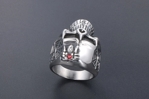 Detail view of a gothic spider ring with a red gemstone and vintage skull accents