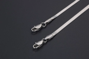 Detailed close-up of silver flat snake chain necklace with secure lobster clasp mechanism