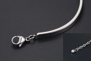 Detail view of silver steel bracelet featuring a lobster clasp and extension chain system
