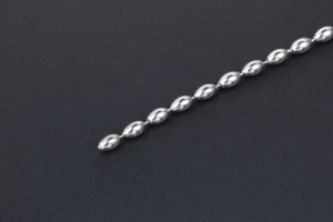 Detailed macro view of polished silver titanium steel oval bead chain necklace links
