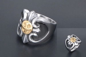 Macro view of punk stainless steel ring with golden eagle emblem and hollow silver band