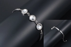 Detailed macro view of silver titanium steel bracelet with three clear crystal gems