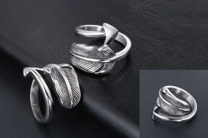 Detailed view of silver feather and arrow rings featuring vintage textured stainless steel