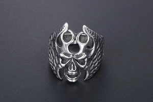 Macro view of vintage stainless steel skull ring with detailed wing texture for men