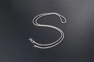 Close-up of polished silver twisted rope chain necklace with classic lobster clasp