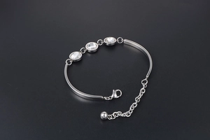 Detail of silver titanium steel bracelet with three faceted crystals and lobster clasp