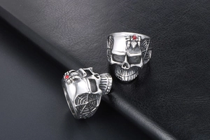 Detailed close-up of gothic skull ring with red rhinestone spider and web pattern