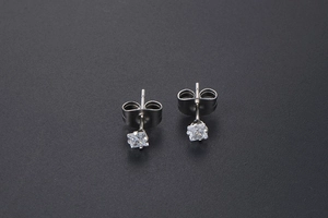 Detail of square-cut cubic zirconia stud earrings with silver-tone polished finish