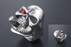 Macro view of punk skull ring with red rhinestone eye detail in stainless steel finish