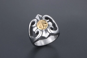 Detailed close-up of retro punk eagle steel ring with golden cross emblem and hollow carvings