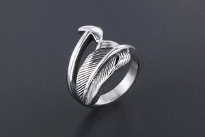 Macro detail of silver feather ring showing vintage textures and punk style engravings