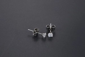 Macro detail of silver titanium square stud earrings with sparkling cubic zirconia stones