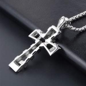 Polished silver stainless steel hollow cross pendant with a box chain on black leather