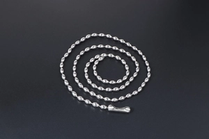 Macro shot of silver stainless steel ball chain with connector clasp and polished finish