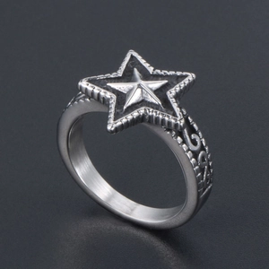 Macro shot of vintage star ring featuring silver textured steel and leaf side carvings