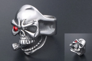Detailed view of punk skull ring with red gemstone eye and cigar in stainless steel
