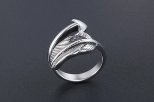 Detailed close-up of feather-shaped titanium steel ring with intricate metallic textures