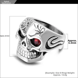 Detailed macro view showing the red stone eyes and dimensions of the skull ring