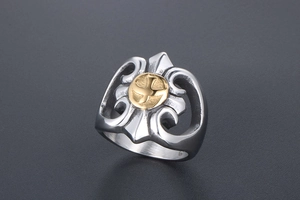 Close-up of gothic punk steel ring featuring a golden eagle crest and floral engravings