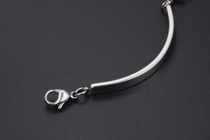 Macro shot of silver titanium steel bracelet with a durable lobster clasp and polished bar