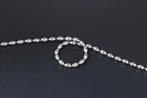 Detailed macro view of silver stainless steel oval bead chain with mirror polished finish