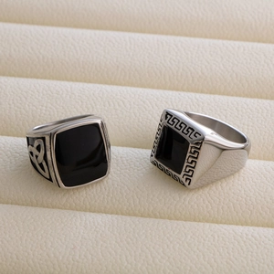 Detailed macro of vintage silver men's steel rings with Celtic and Greek key patterns