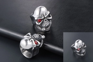 Macro shot of punk skull ring in silver steel with striking red gemstone eyes details