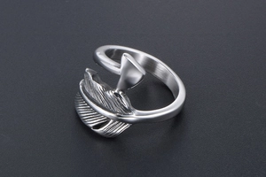 Macro detail of silver feather arrow ring showing intricate vintage texture and steel finish