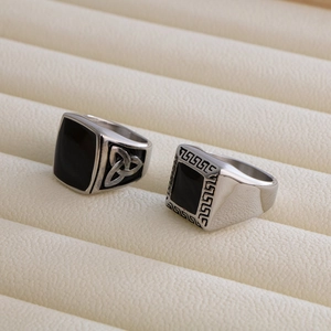 Detail of vintage steel rings with black square stones and Greek meander pattern