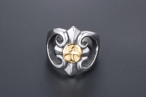 Macro shot of punk style steel ring with engraved eagle crest and cross patterns