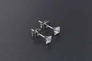 Close-up of square cut zircon stud earrings with silver stainless steel butterfly backs