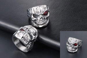 Macro shot of punk skull ring with red eye stones and vintage steel carving details