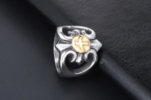 Macro shot of retro stainless steel ring with golden eagle emblem and hollow carving