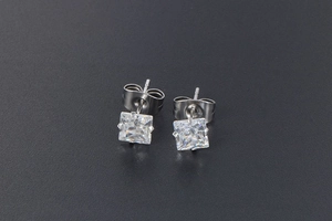 Detail view of titanium steel stud earrings with square cut zircon and butterfly backings