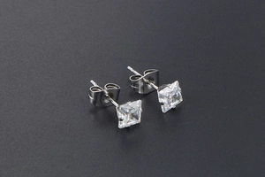 Macro detail of silver titanium square-cut cubic zirconia stud earrings with butterfly backs